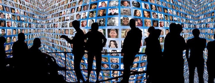 Silhouettes standing in front of a large collage of profile photos