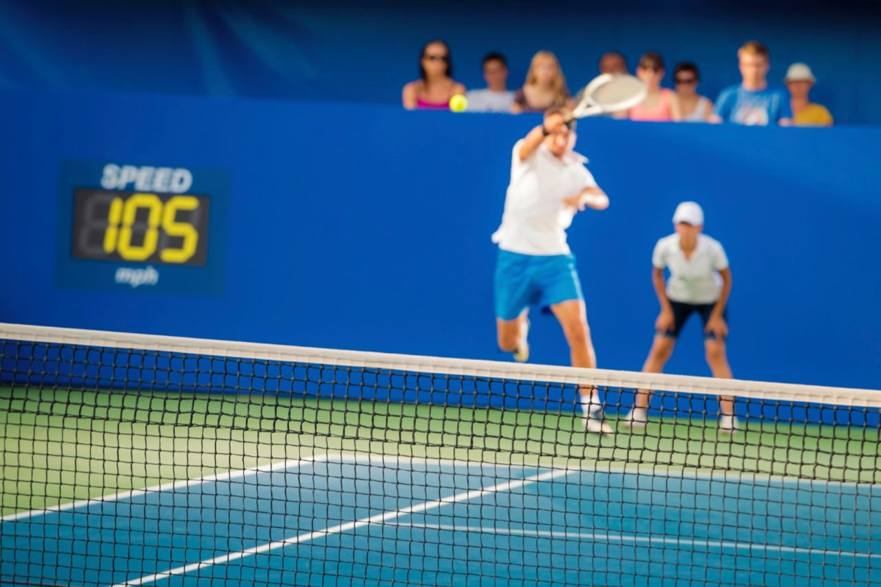 A tennis player returns a serve at speed. Image: iStock