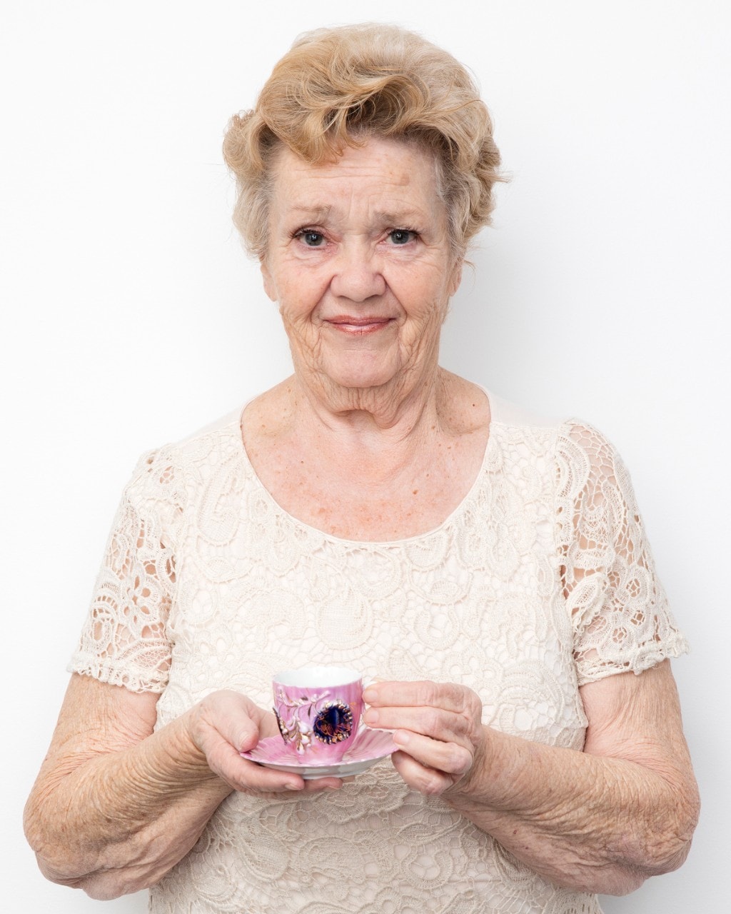 Treasured Possessions participant Maureen Lyndon holds an ornate pink tea cup. Image: Jason Cole
