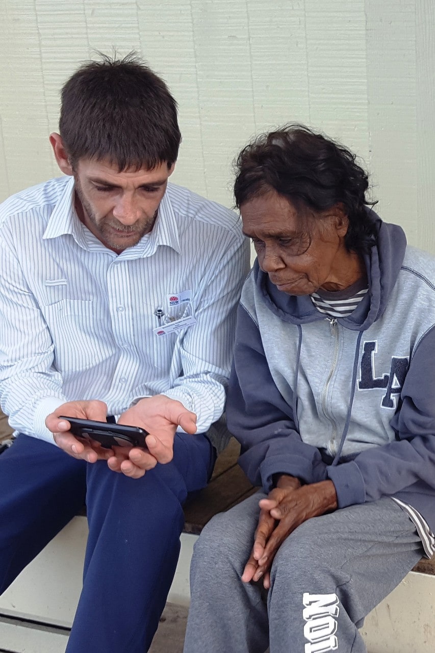 A photo of Aboriginal health workers Dan Kelly and Frances Coffey using the iECG device. 