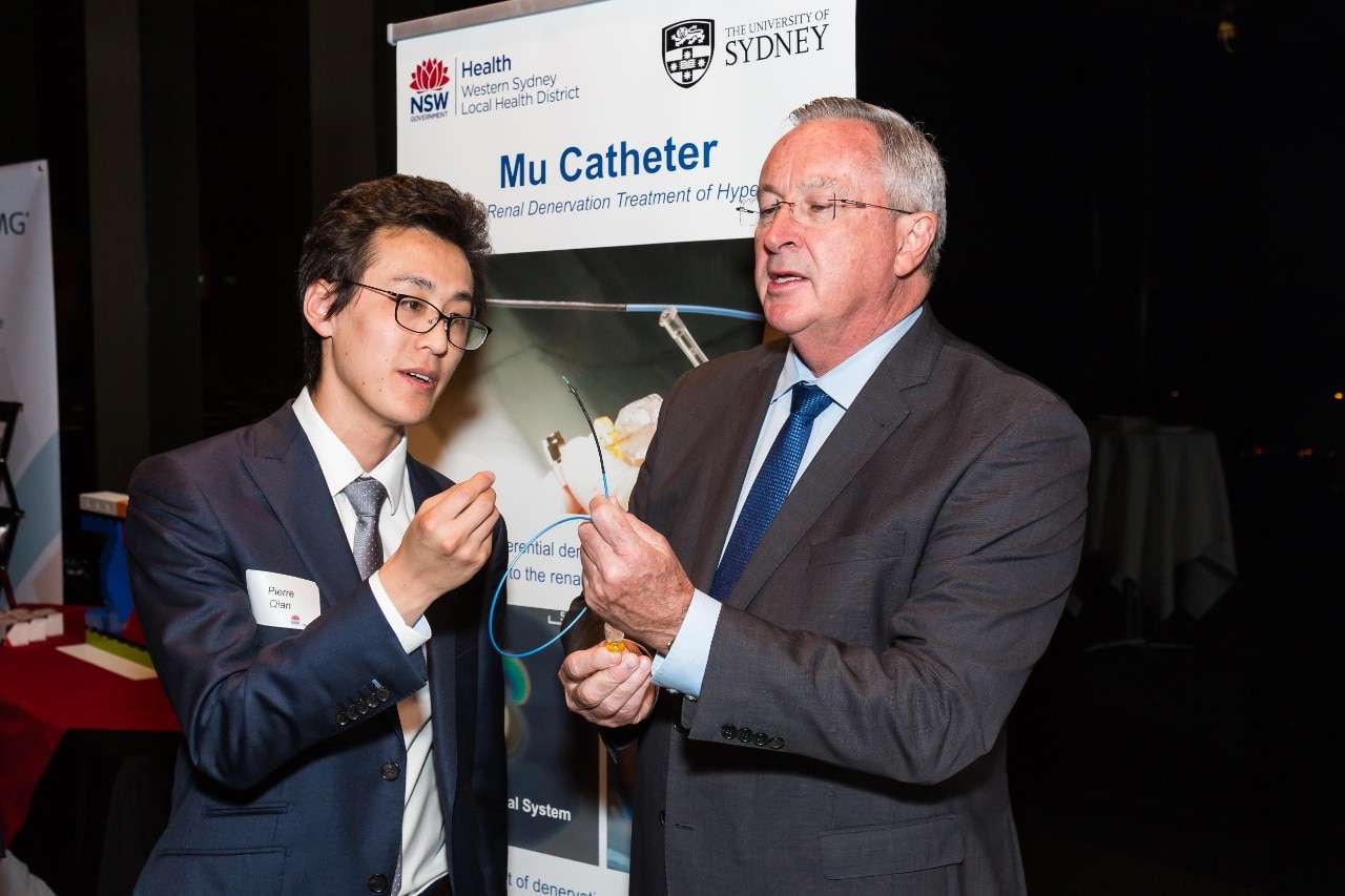 Dr Pierre Qian shows the Mu Catheter device to NSW Health Minister Brad Hazzard.