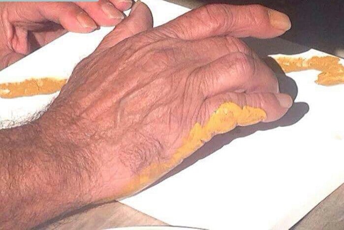 A hand of an Aboriginal and Torres Strait Island man