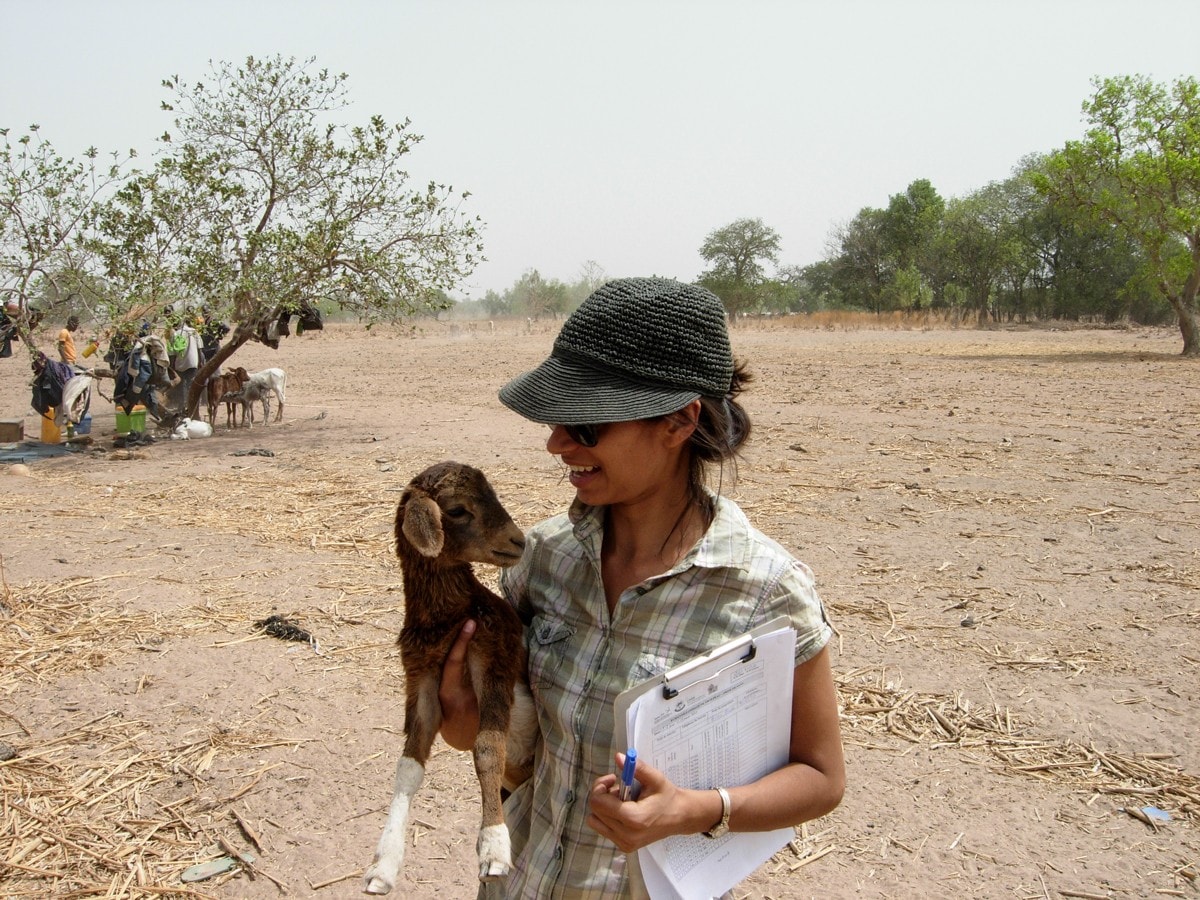 Anna Dean with a baby goat in a rural community in Togo, West Africa