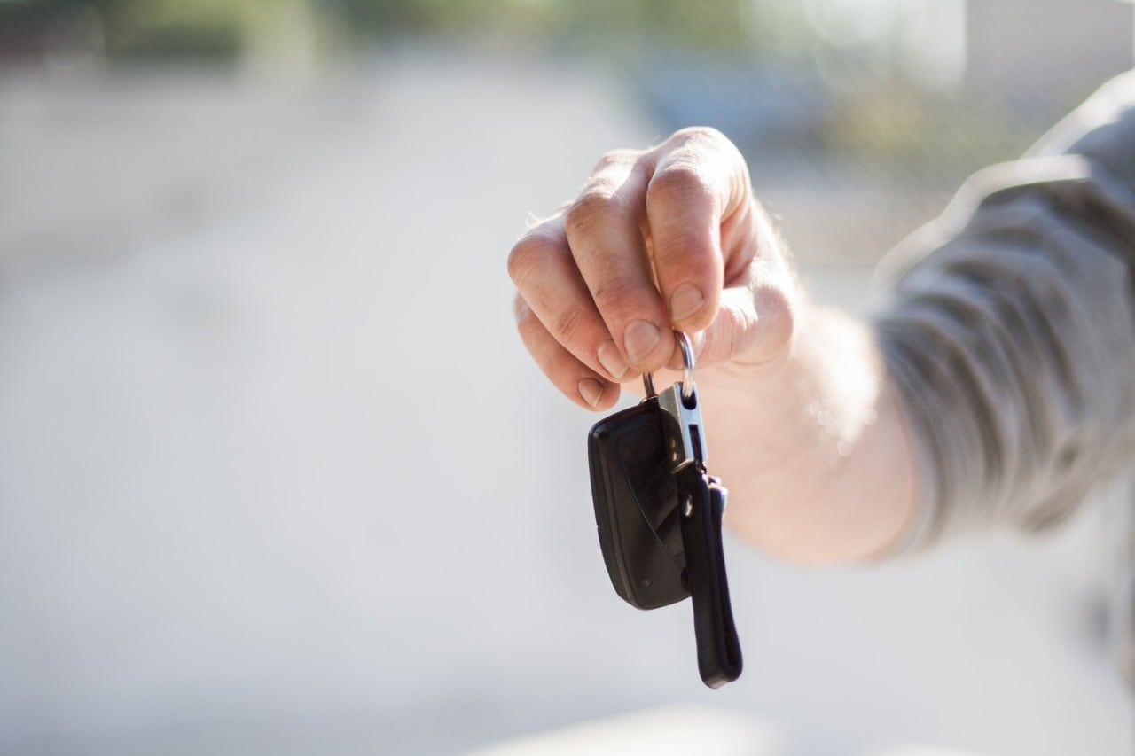 Uber driver holding out car keys. 