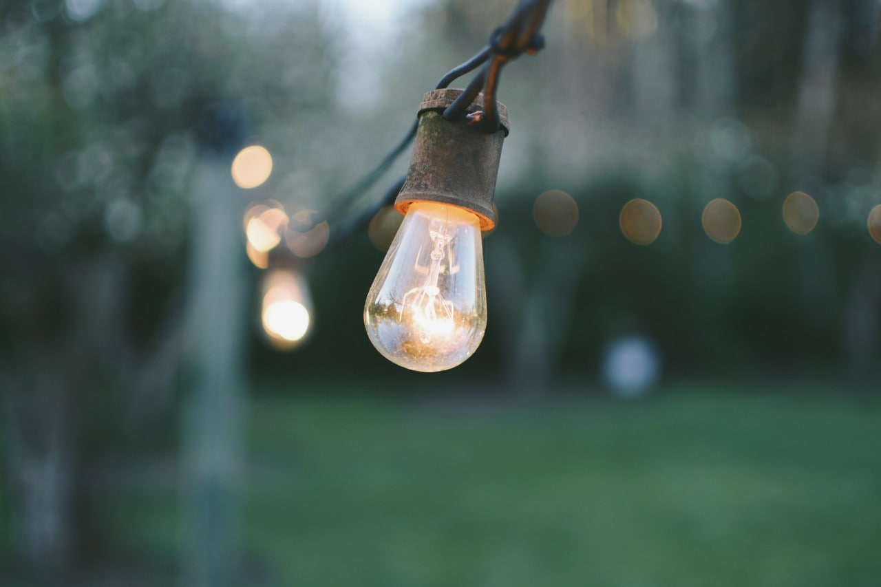 A string of lights in an outdoor space.