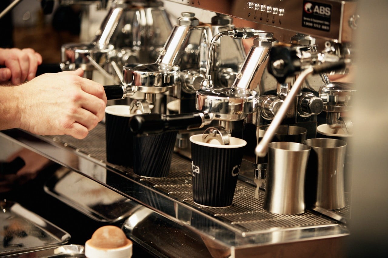 Close up of coffee machine with mutliple take away coffee cups