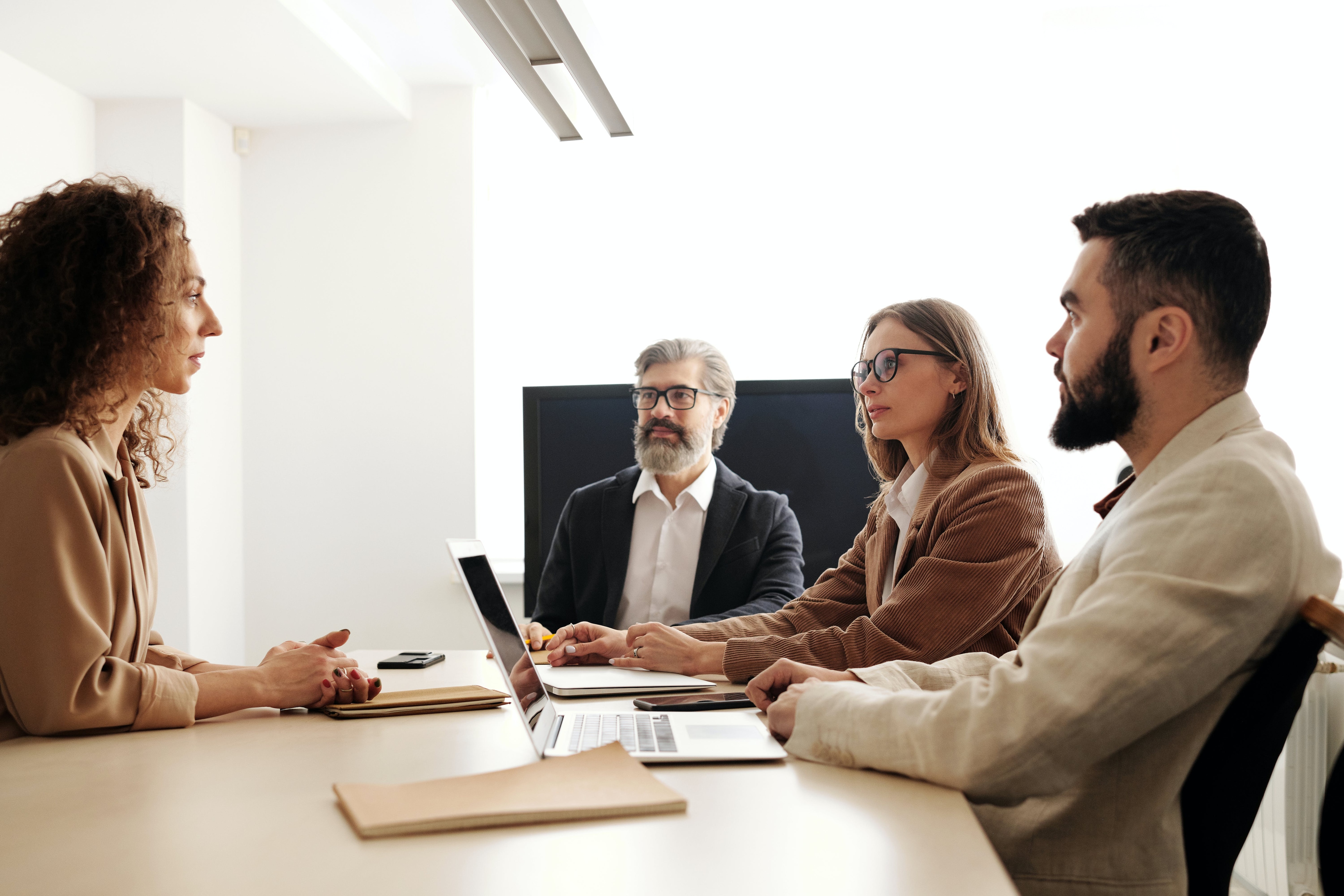 Photo of people at table in interview setting.