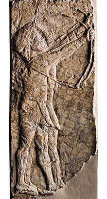 Limestone carving of two Assyrian archers