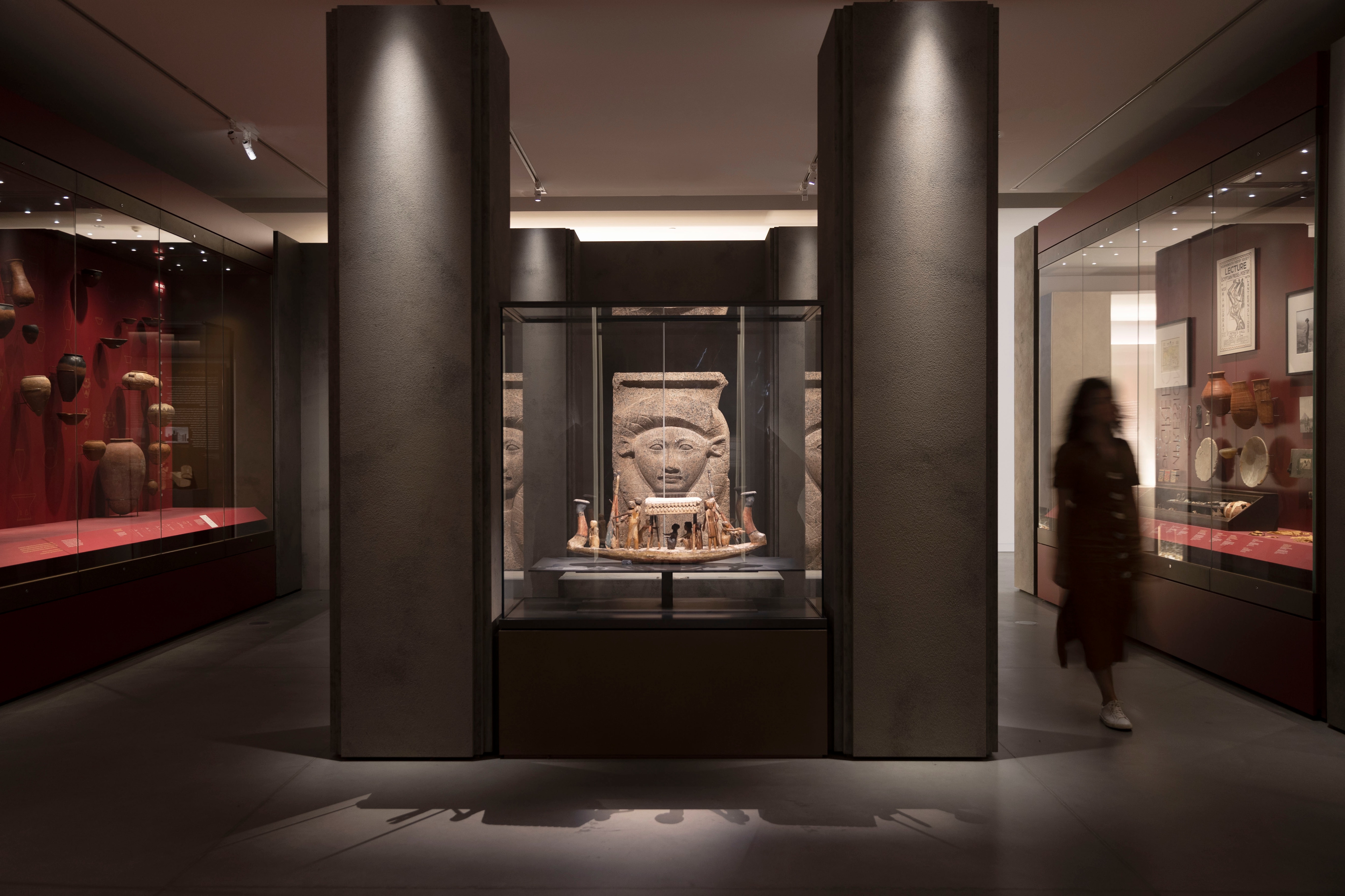 A blurred figure walks through the 'Pharaonic Obsessions' exhibition at the Chau Chak Wing Museum