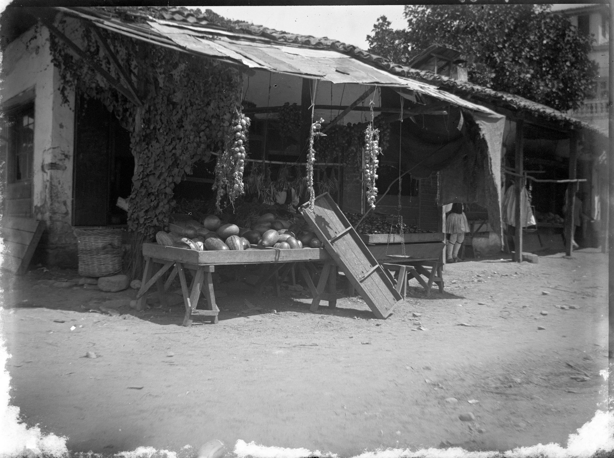 A black and white image of a fresh produce stall in Greece