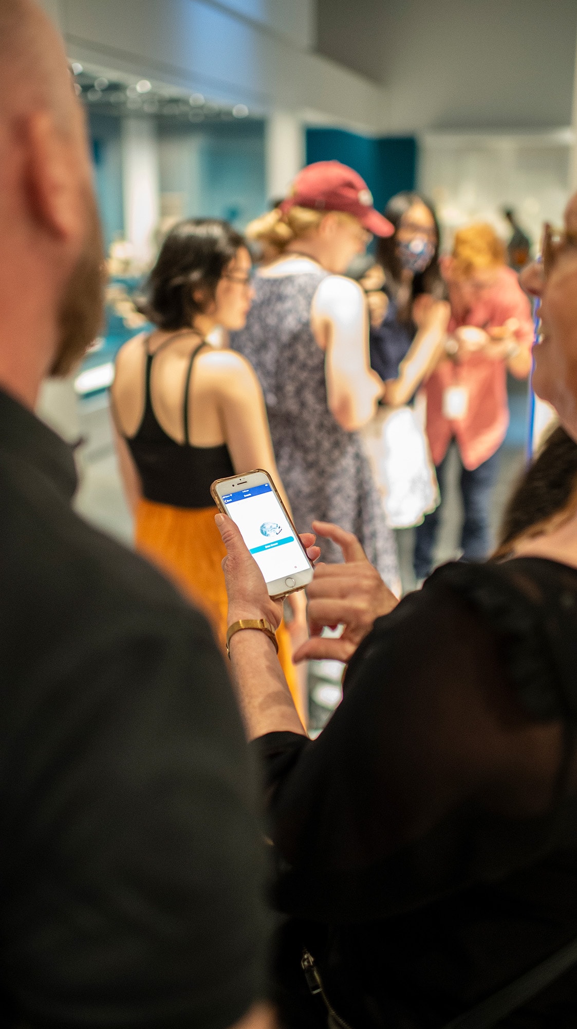 A person uses their phone in the Museum