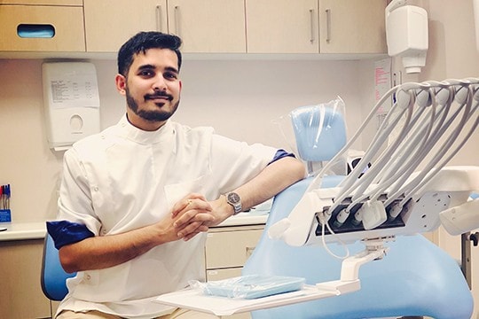 Dr Mohit Tolani beside a dentist chair