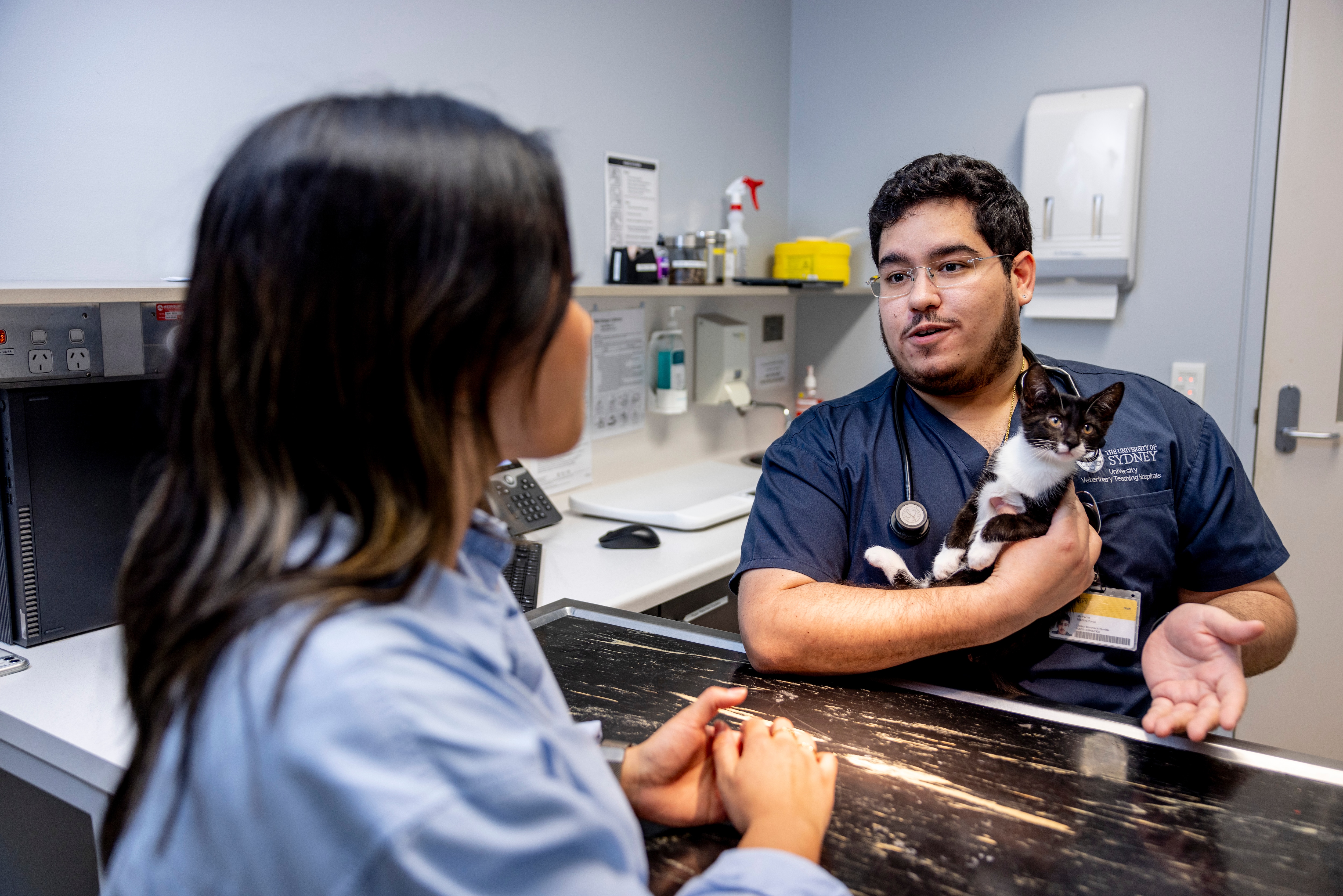 vet with cat in consultation room