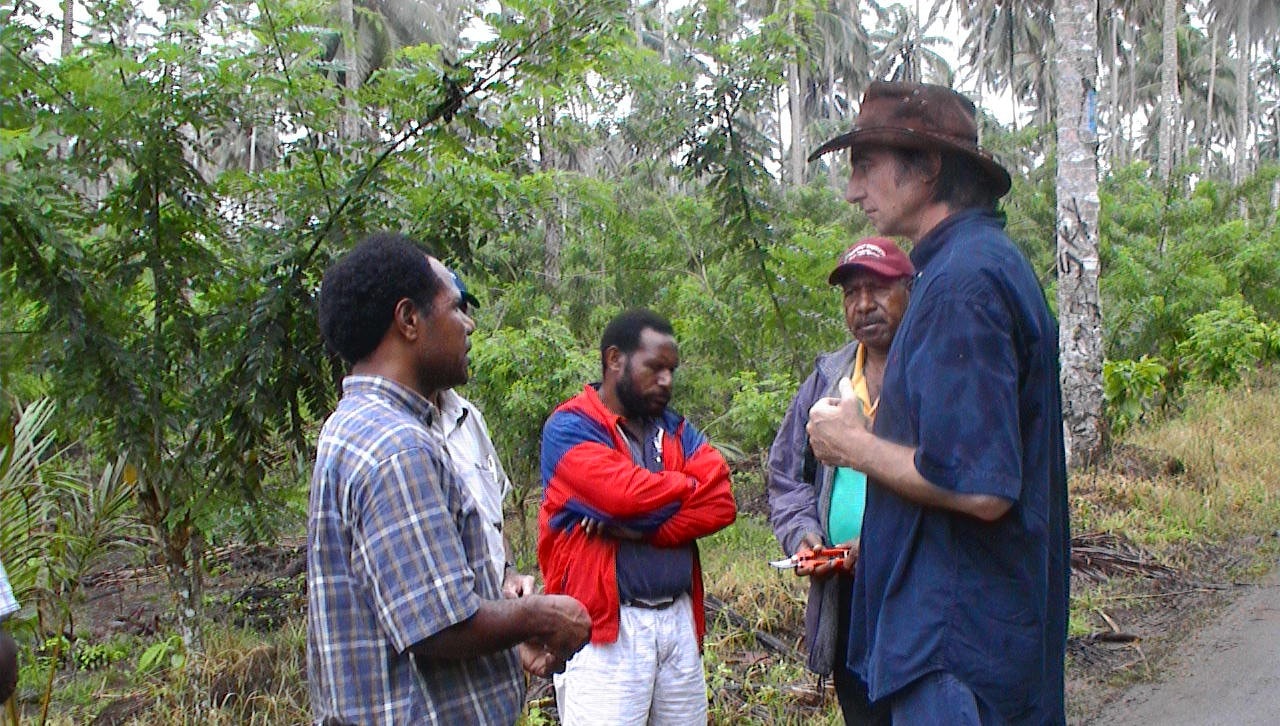 David Guest chatting with a group of cocoa farmers in Papua New Guinea