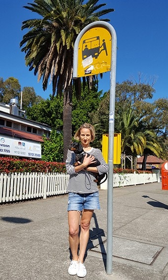 Dr Jennifer Kent with her dog Olive standing at the bus stop.