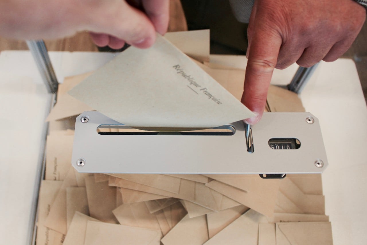 A ballot paper is slipped into a ballot box in France. Image: Arnaud Jaegers