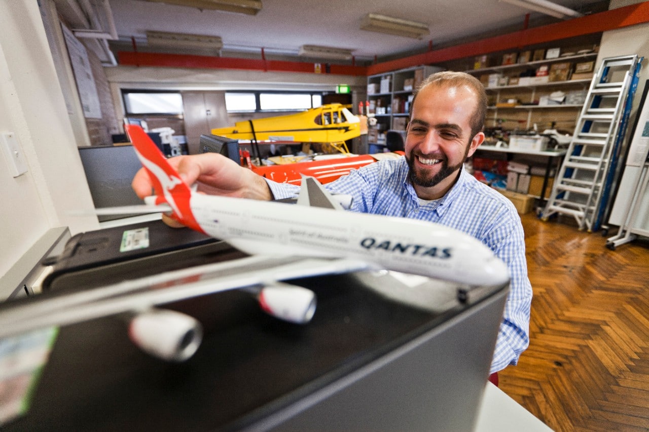 Professor Salah Sukkarieh with a model of a Qantas plane.