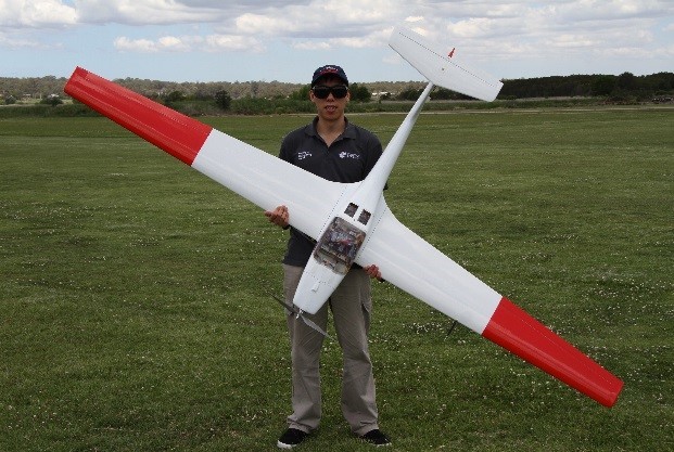 PhD candidate Andrew Gong with the aircraft used during the hydrogen fuel cell-powered flight trials in 2017.