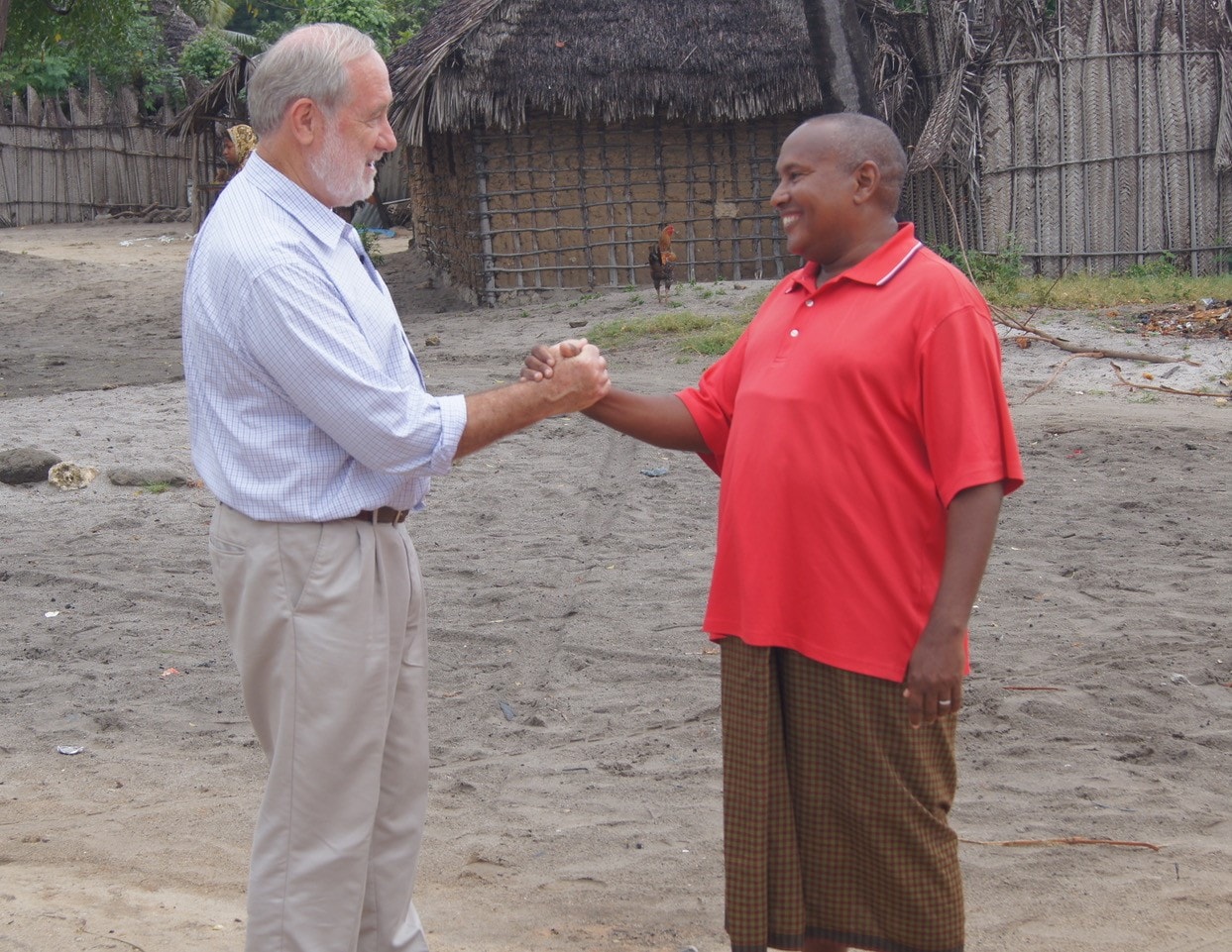 Professor Charles Mackenzie shaking hands with a patient in Tanzania