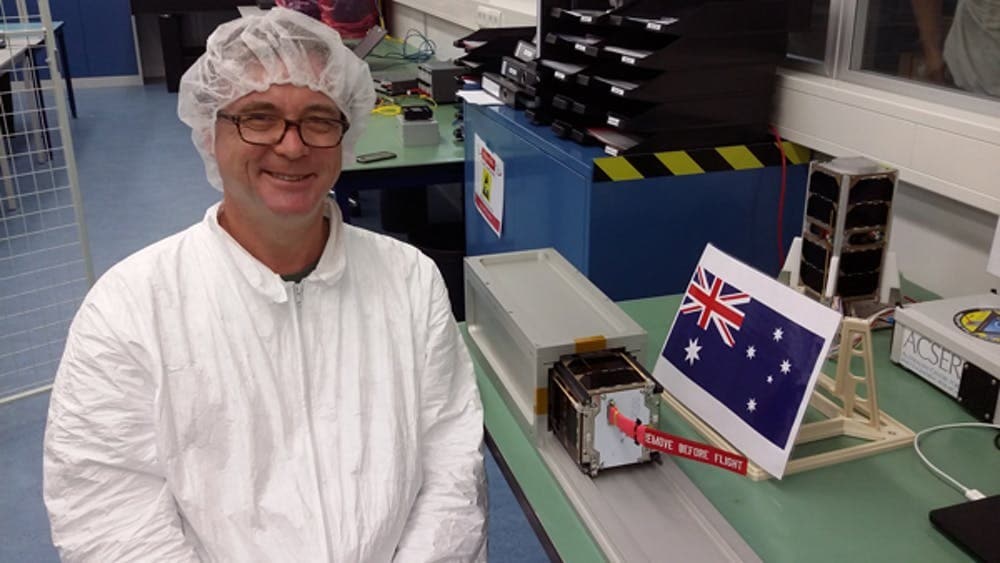 Photo of Professor in Space Physics Iver Cairns with a CubeSat.