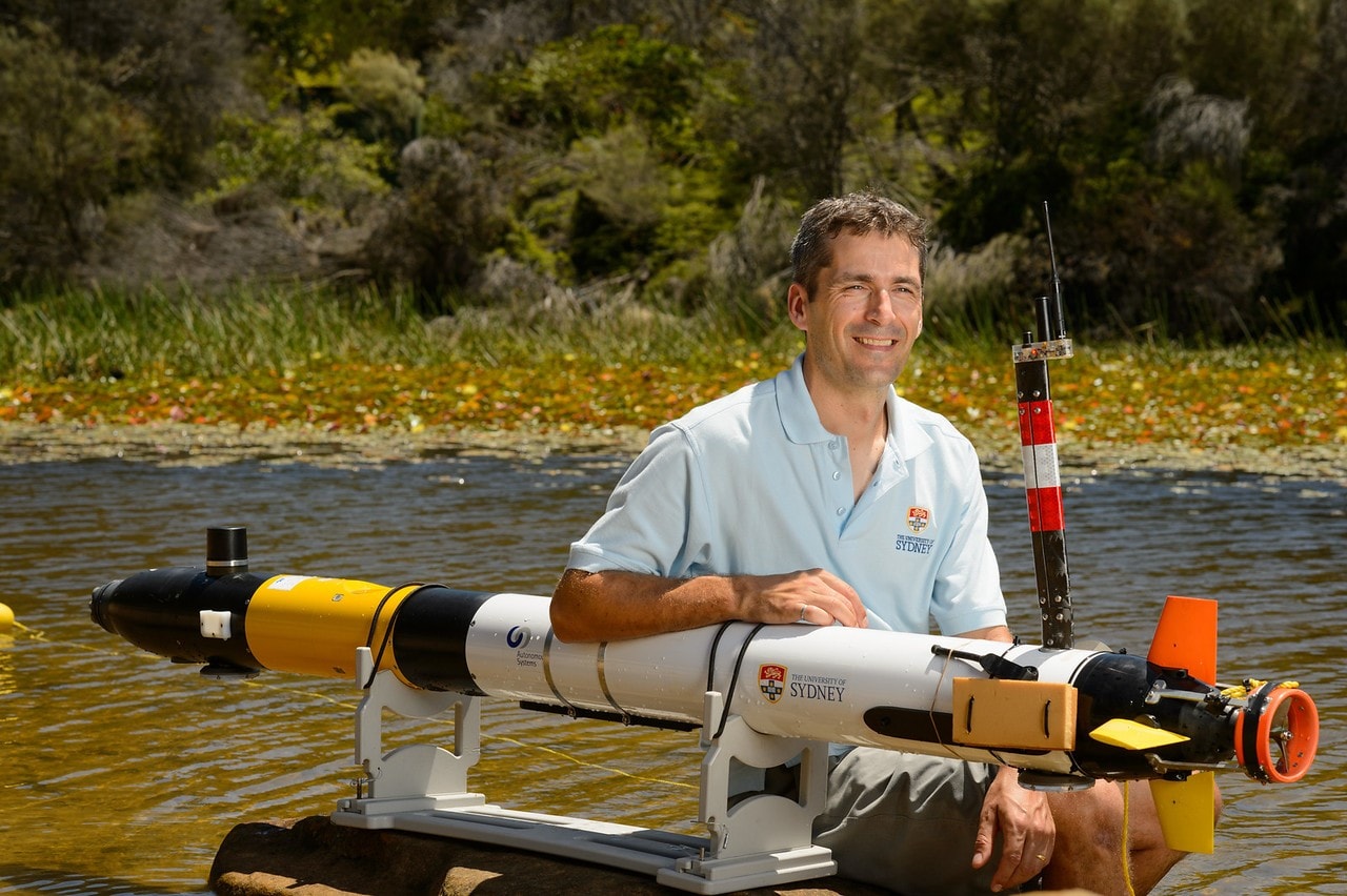 Professor Stefan Williams with an autonomous underwater vehicle.