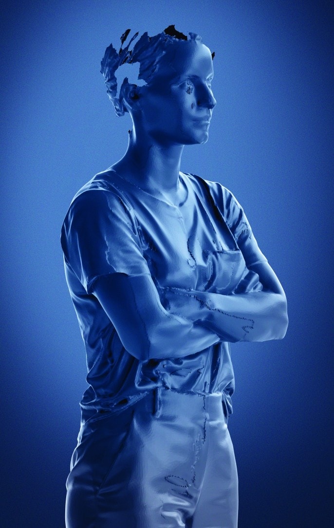 A partial, sci-fi looking computer-generated image of Cheng with folded arms. The images is made up of vivid tones of blue.
