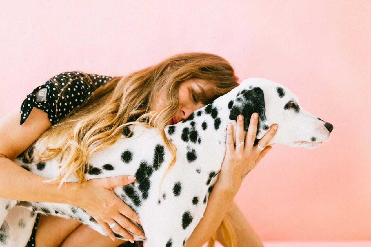 photo of a woman hugging a dog