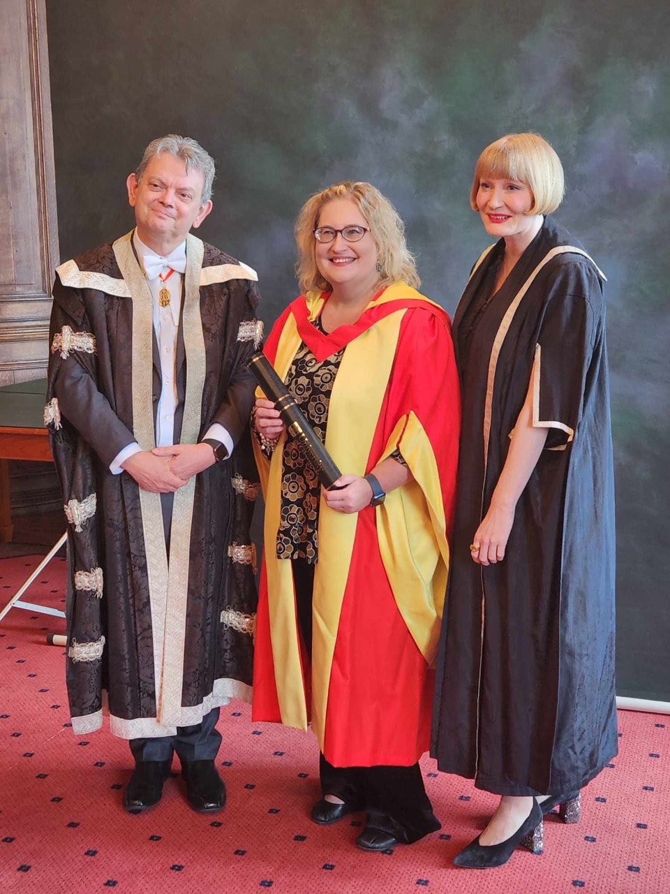 Professor Kathy Belov in academic robes after receiving her Honorary Doctorate