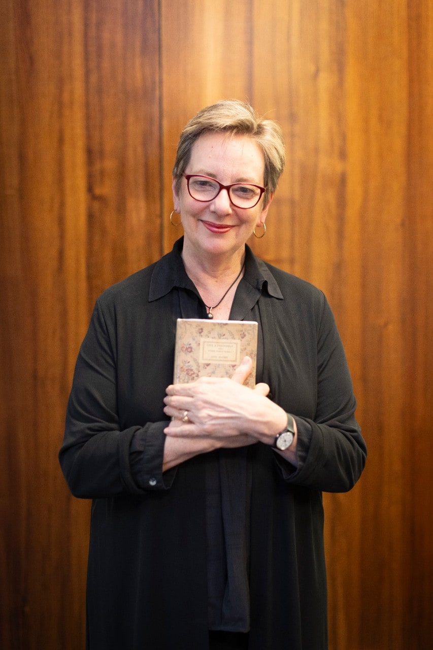 Professor Louise Baur clutching a book 