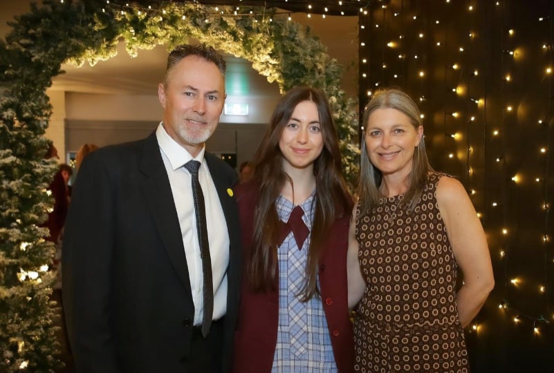 Maeve with her family at her school graduation.