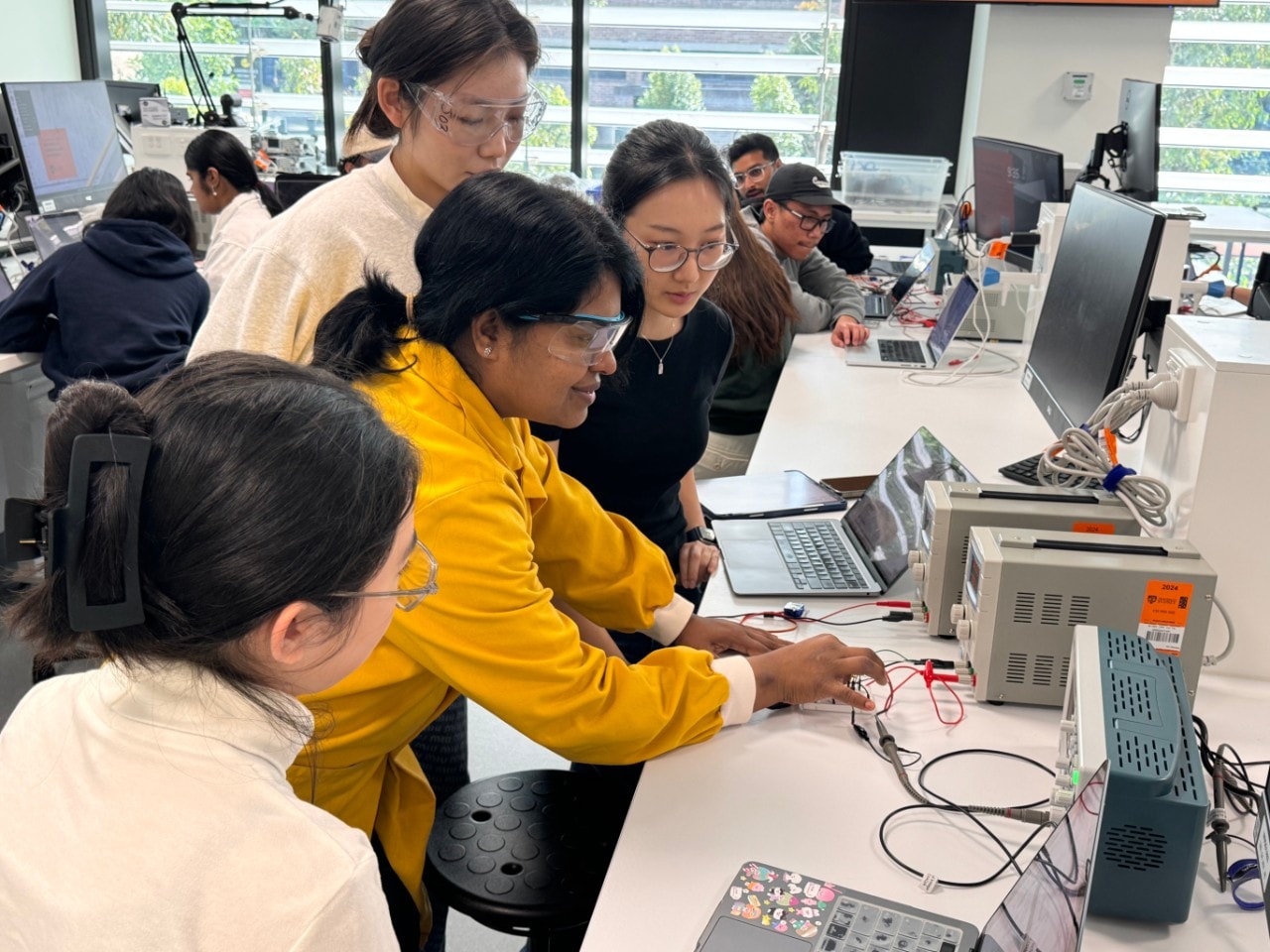 Professor and students doing activity in a lab