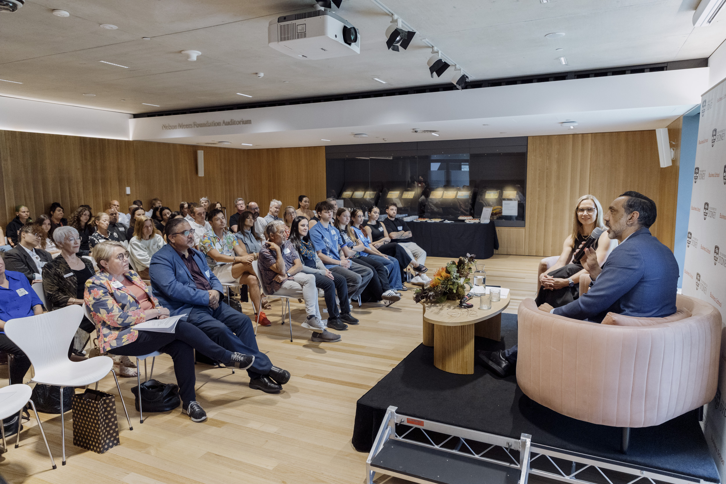 A room full of people listening to Adam Goodes