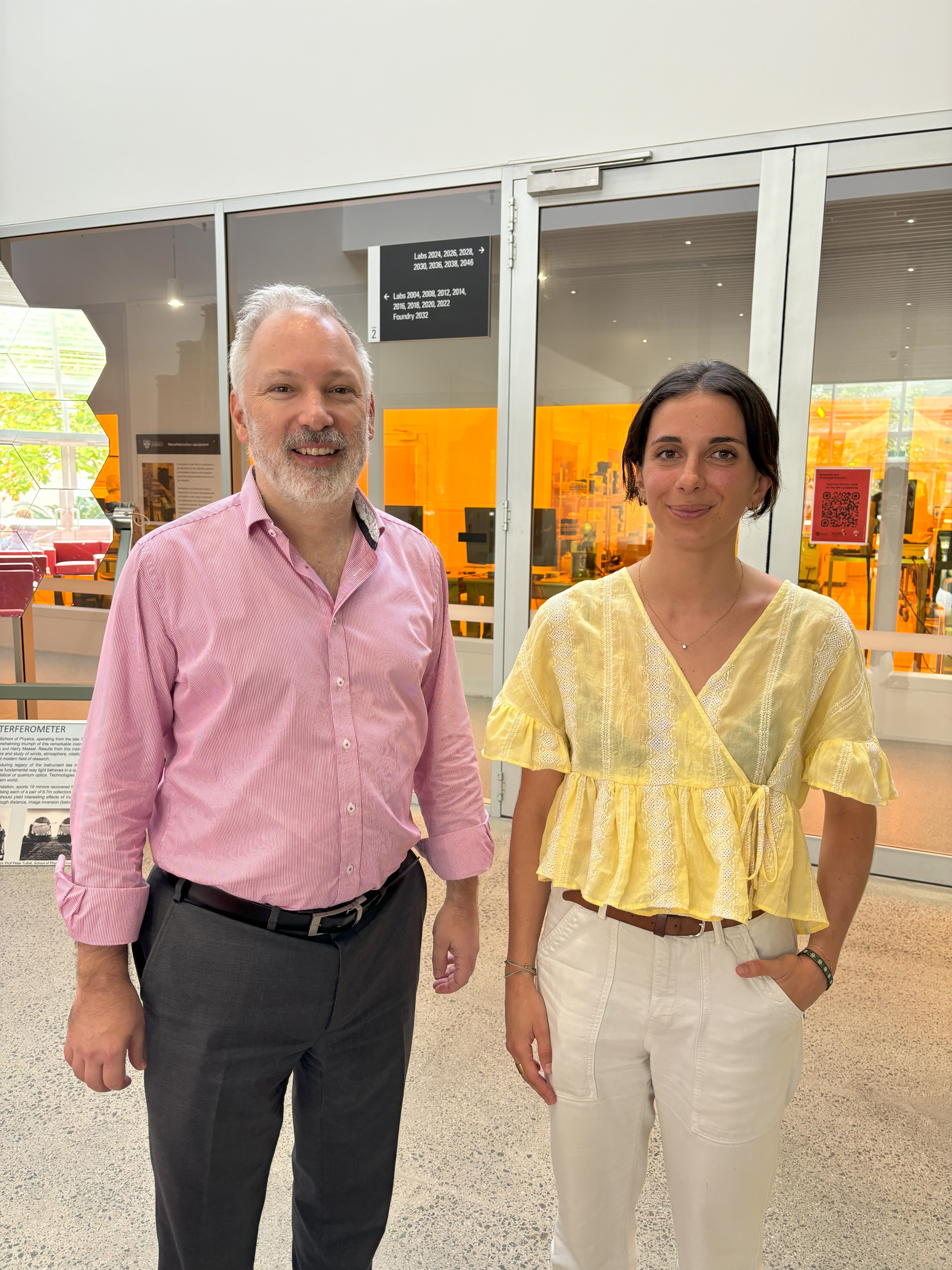Professor Stephen Bartlett and Constance Laine pose in front of the lab at the Sydney Nanoscience Hub