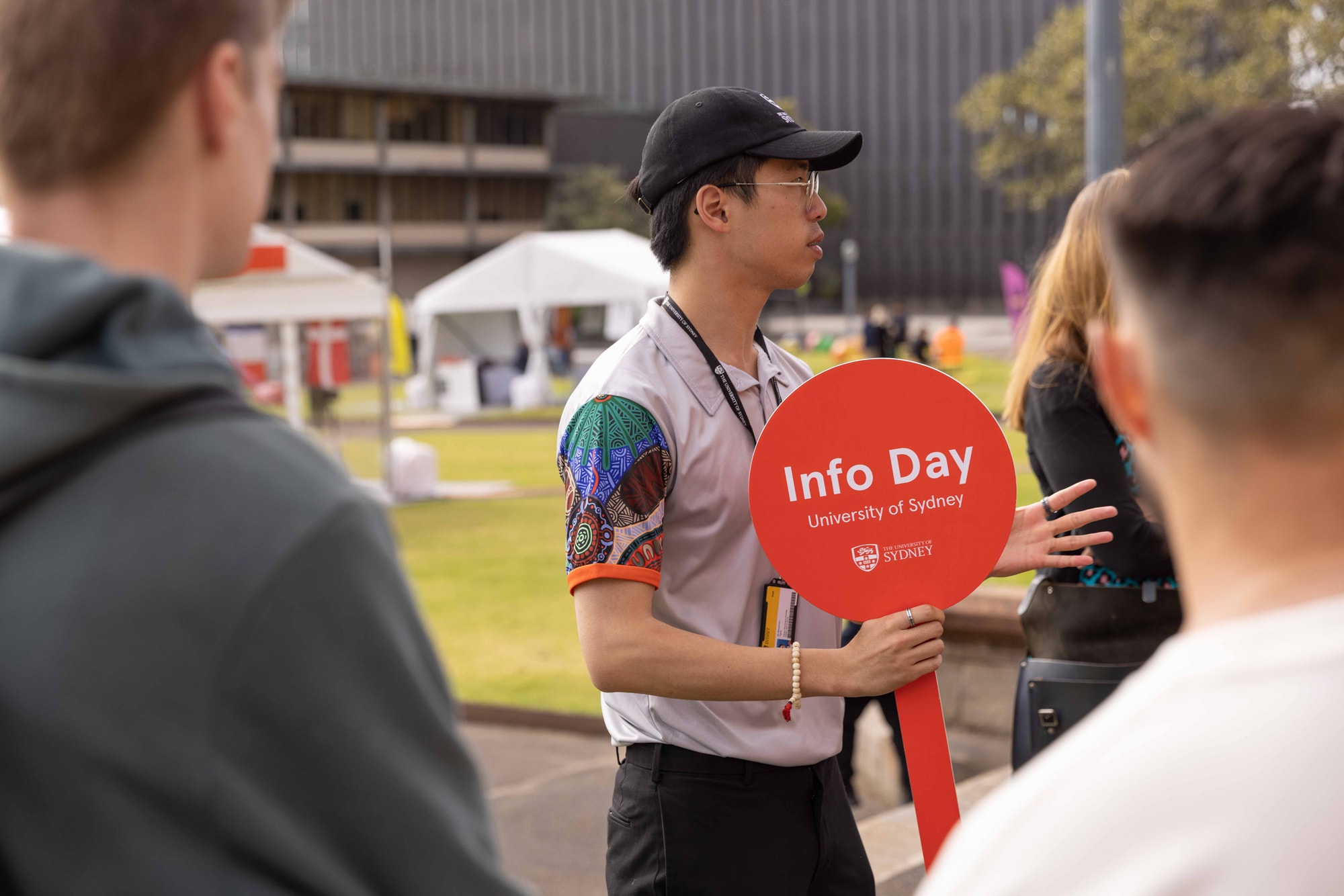 tour guide holding info day sign