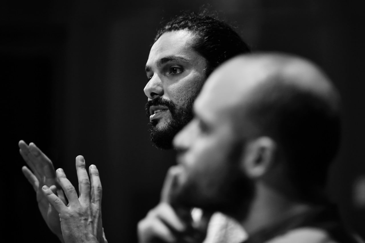 Black and white image of Luka Lesson with producer Jordan Mitchell pictured, blurred, in the foreground.