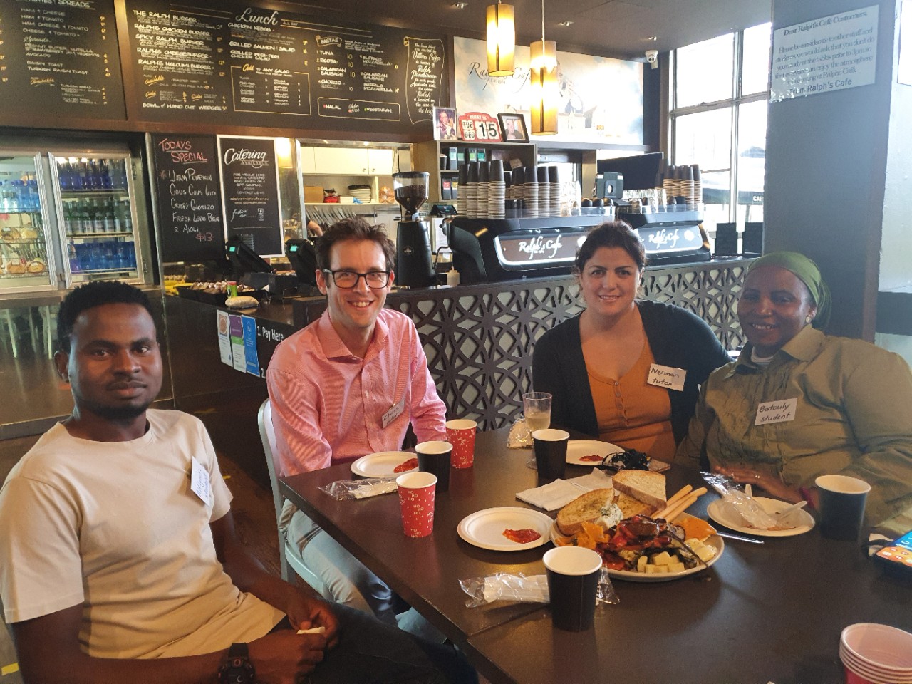 Volunteer and students in a cafe