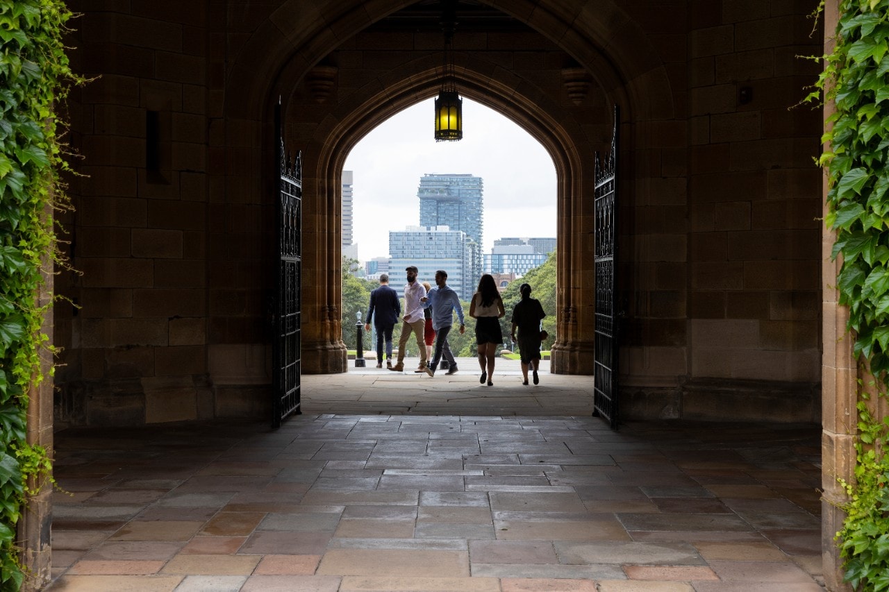 Business recruitment photography. Students Meghal Shah (beard), Ali Besiso (Blue shirt), Cale Maxwell (tall with jacket), Mayuri Manraj (white shirt and glasses), Isabelle Malvar (black skirt), Ollie Nguy (pregnant, green dress), Katherine Passmore (red dress). Law School steps. Abercrombie Business School.