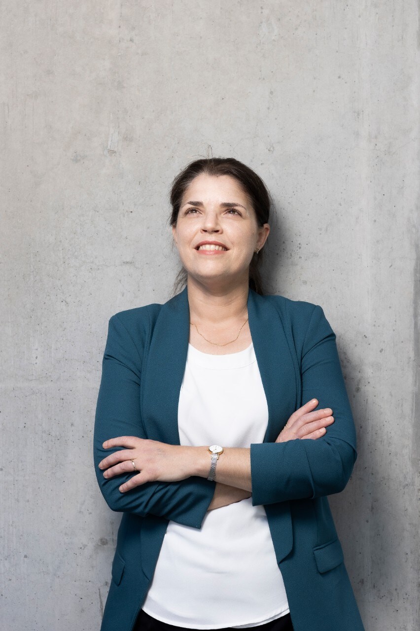 Professor Deanna D'Alessandro looking into the camera, smiling with her arms foldeed