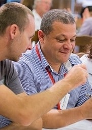 Two teachers in discussion in a lecture