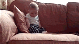 gif of a baby falling asleep on the sofa