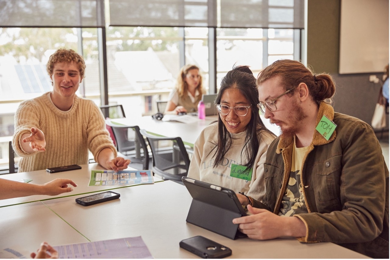 Students in a classroom using a tablet device