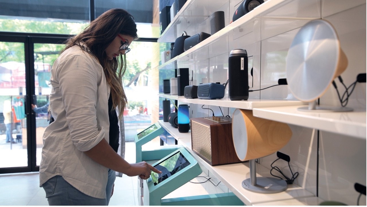 A student in a retail store using a tablet-like device