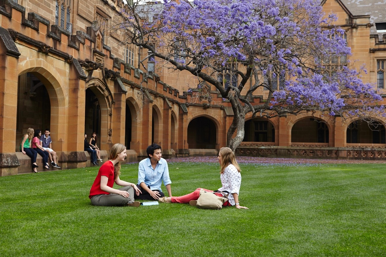 Students walking through the archway at the University's Quadrangle. 