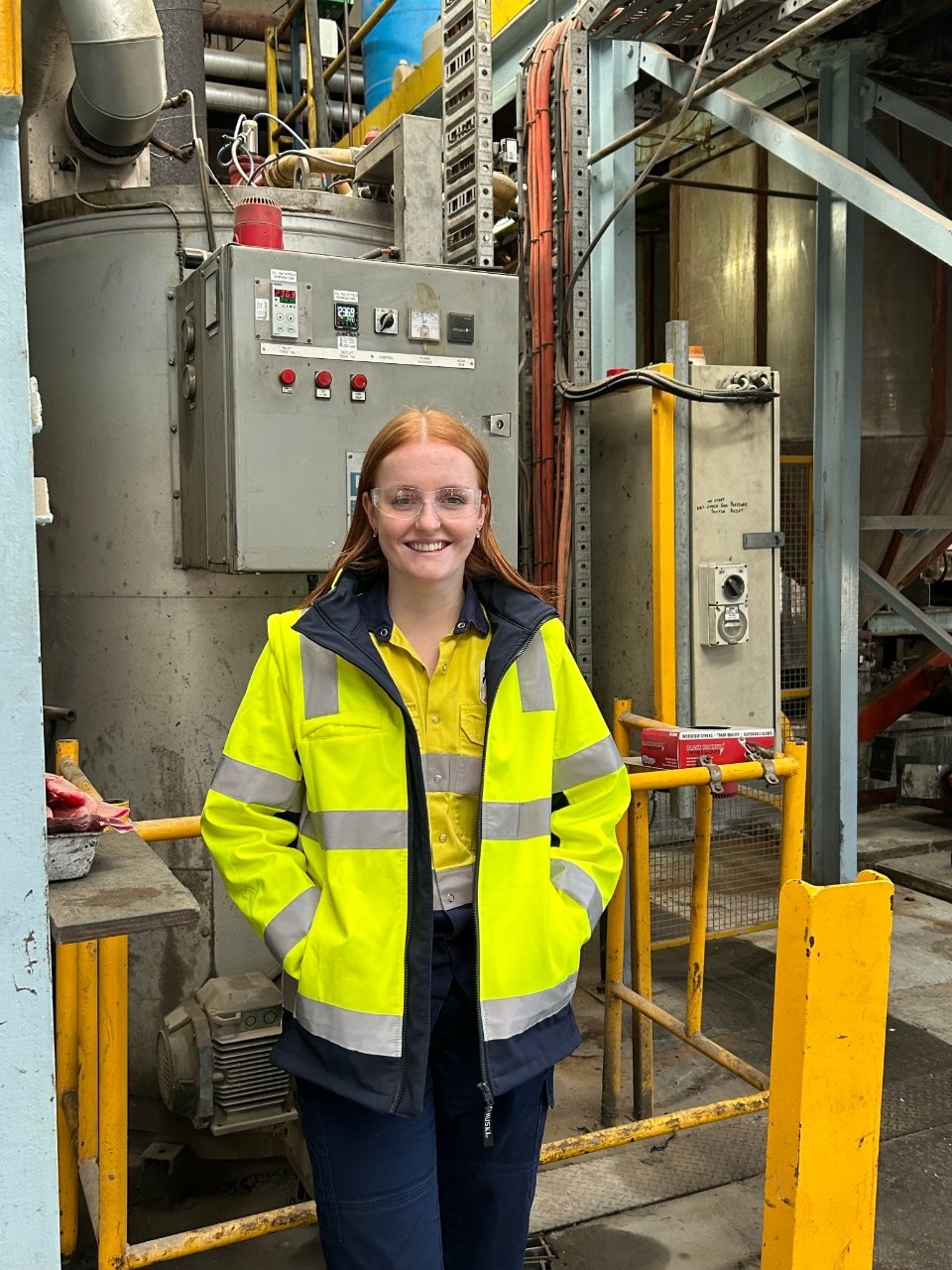 Laura Tighe standing in front of machine