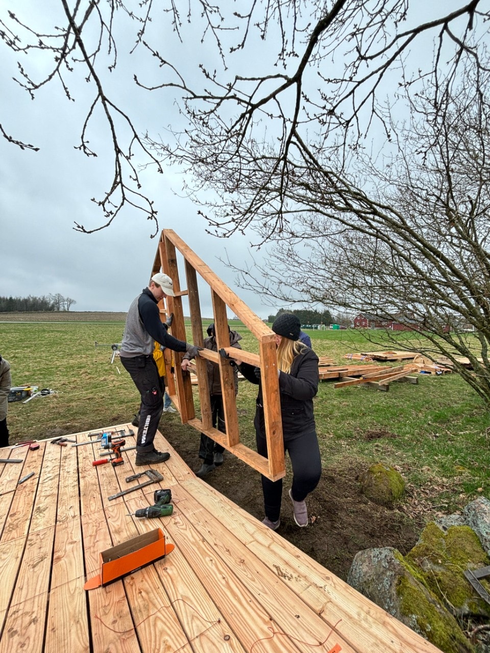 A group of people constructing a wooden structure