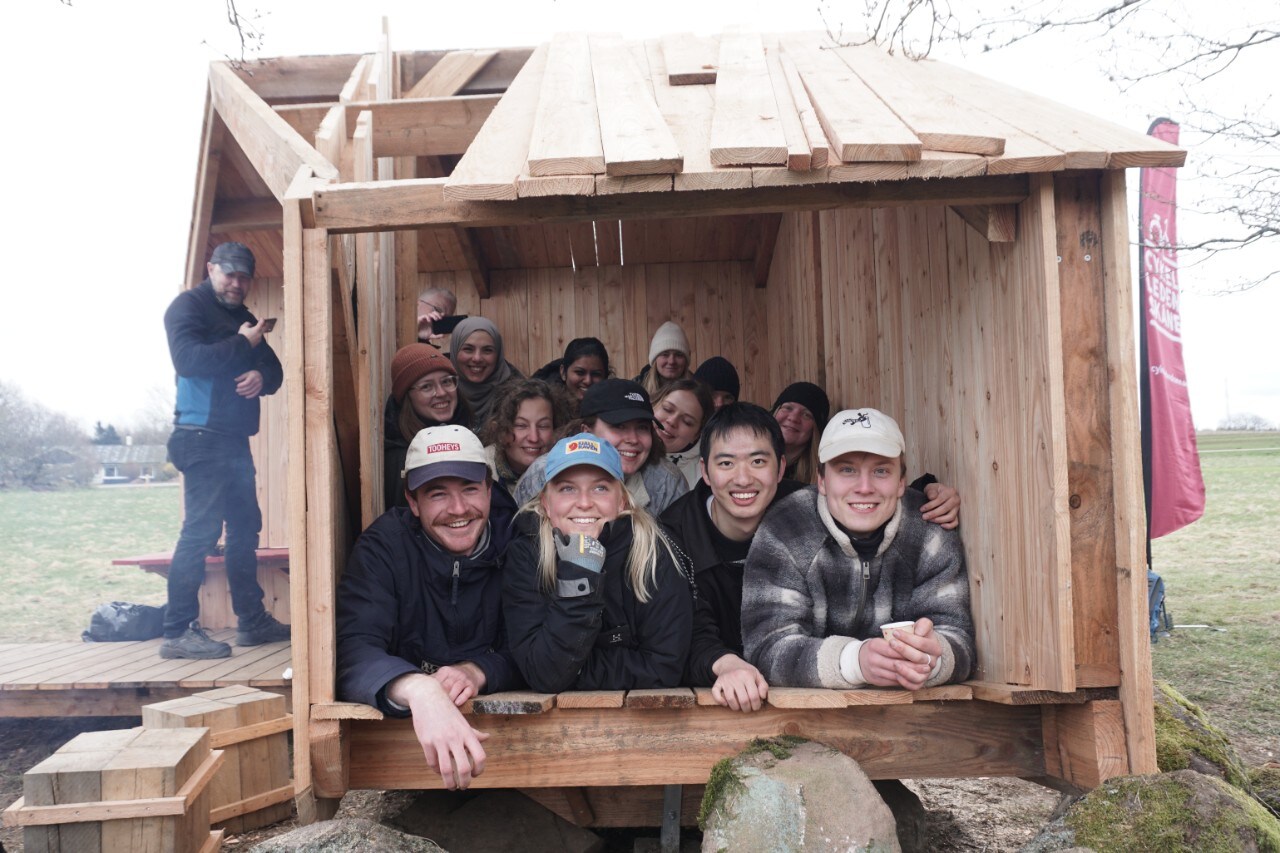 A group of people sitting in a wooden structure