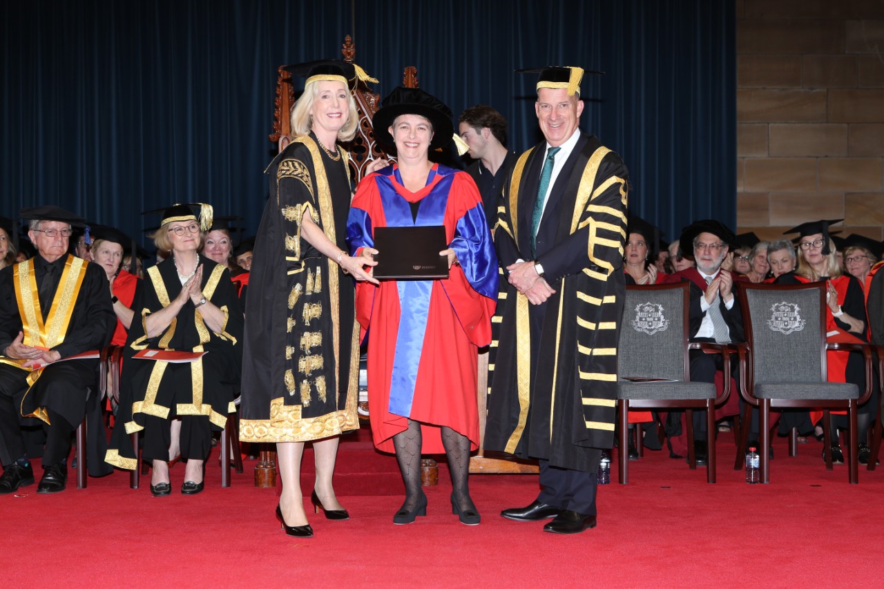 The Honourable Nicola Roxon receives Doctor of Laws from Chancellor of the University of Sydney Belinda Hutchinson AM and Vice-Chancellor and Principal Dr Michael Spence AC.